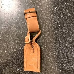 Louis Vuitton leather luggage or bag tag.